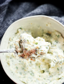 spoonful of compound butter with fresh parsley thyme and basil