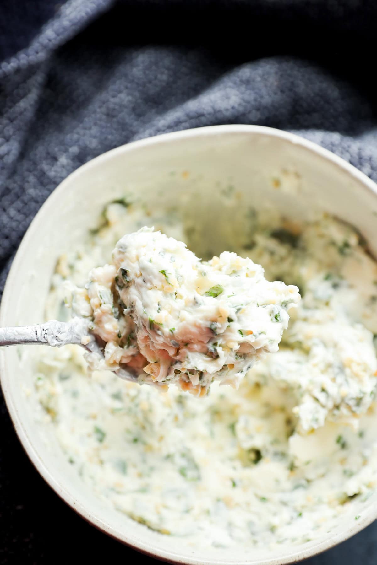 spoonful of compound butter with fresh parsley thyme and basil