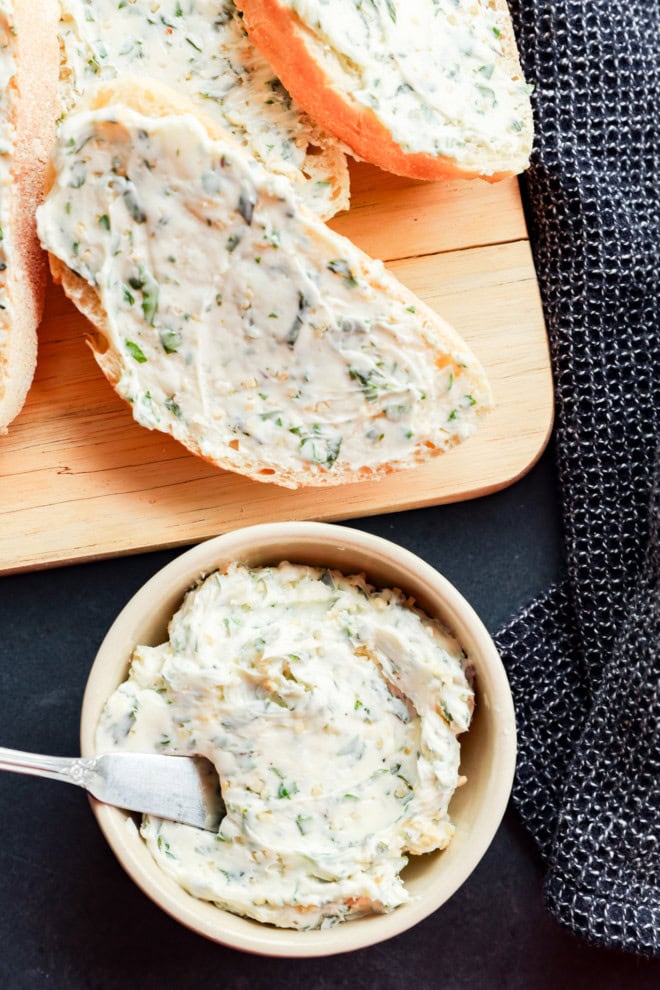 garlic herb butter in a bowl and spread on bread slices