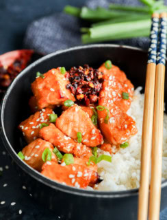 bowl of salmon bites glazed with honey sesame ginger marinade