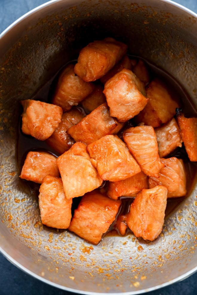 cooked fish pieces in bowl with glaze