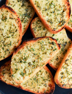 easy fresh herb bread slices on a plate with butter