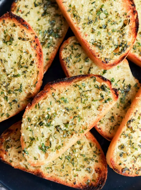 easy fresh herb bread slices on a plate with butter