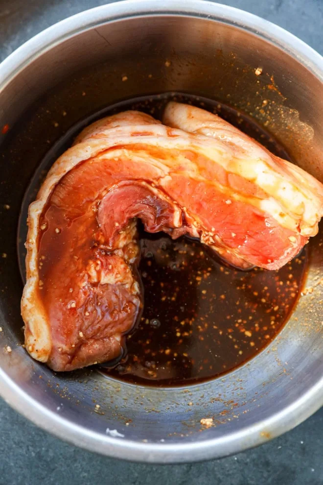 pork belly in asian pork belly marinade in a bowl