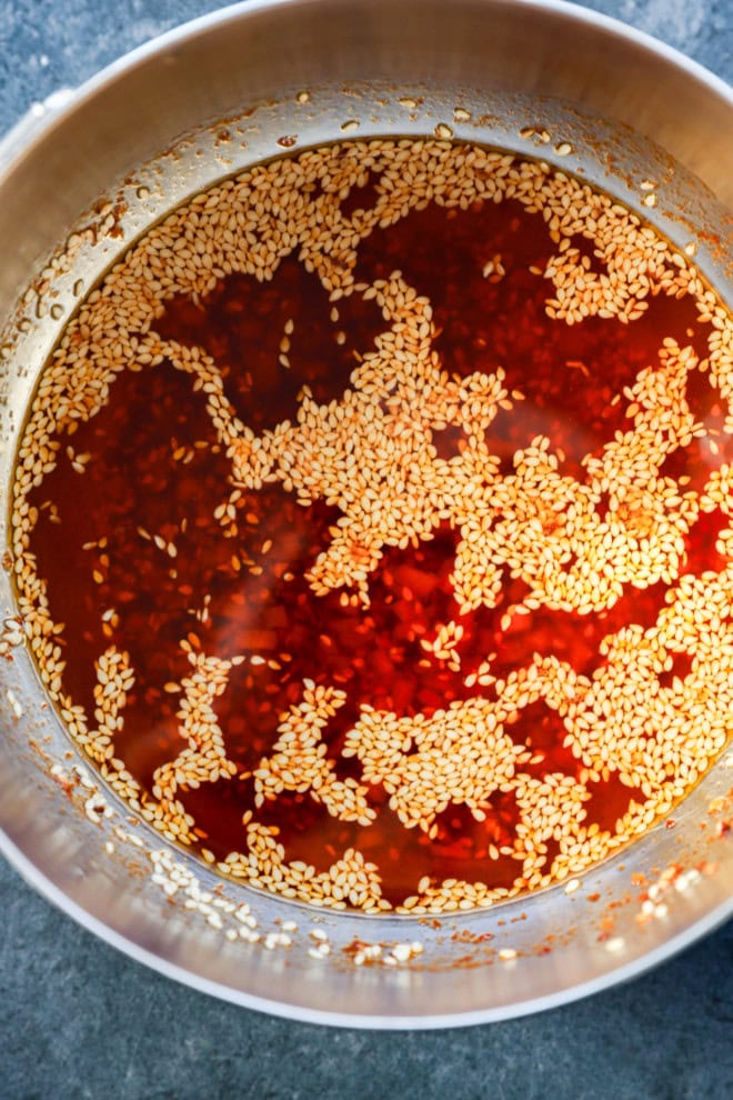 sauce in bowl with red pepper flakes and sesame