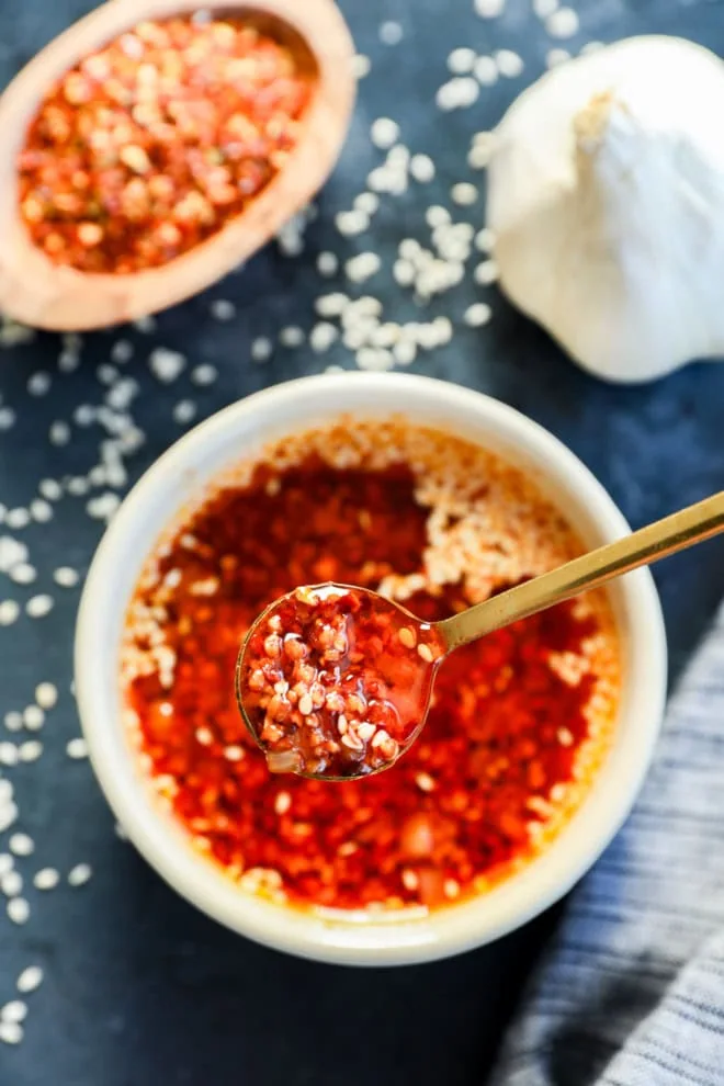 spooning out spicy mixture from a bowl