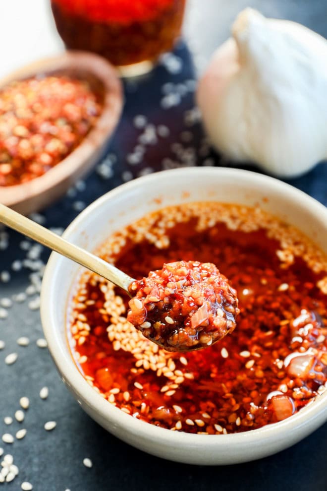 spooning out chili garlic oil recipe from a bowl