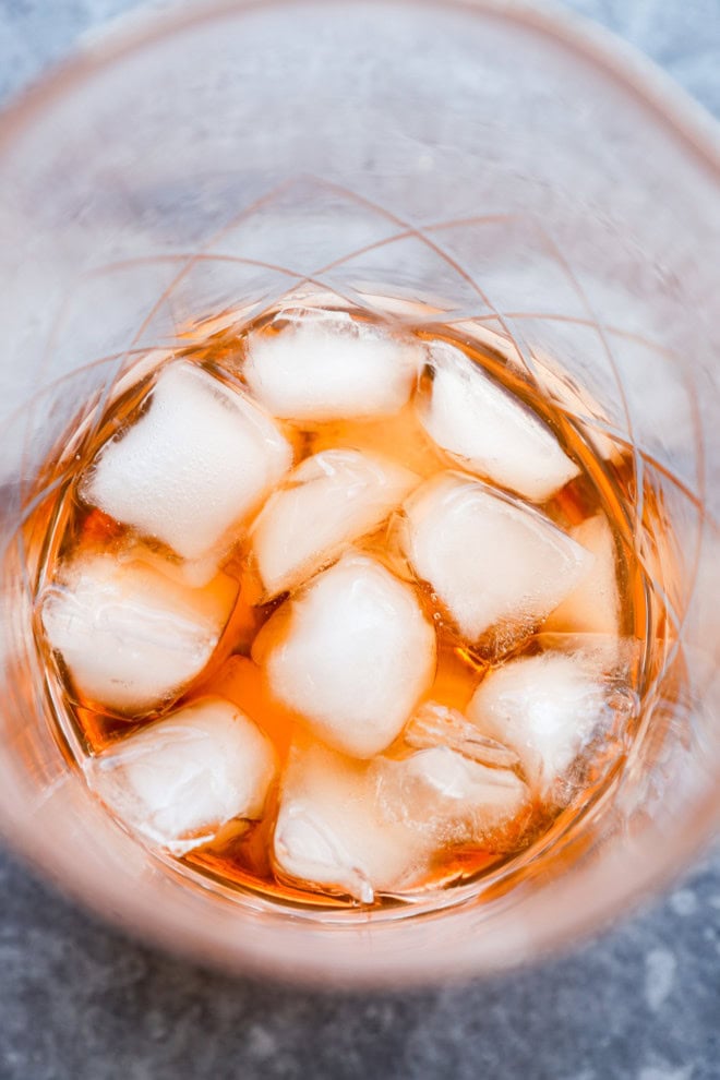 pink gin cocktail stirred together in mixing glass