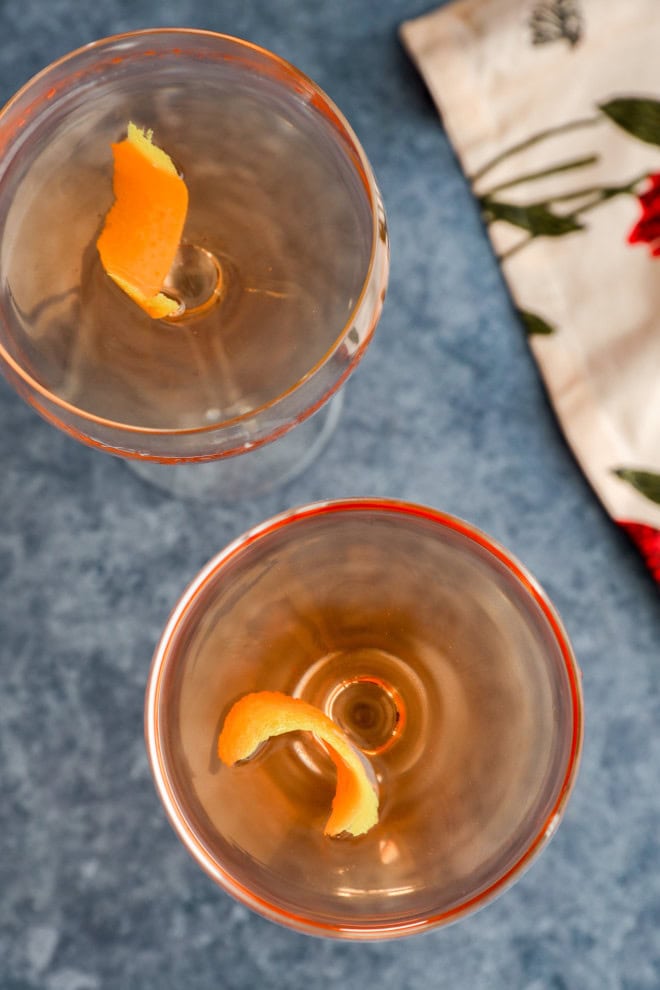 overhead image with cocktails in coupe glasses with lemon twists