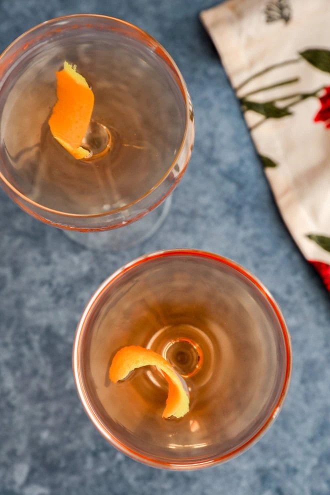 overhead image with cocktails in coupe glasses with lemon twists