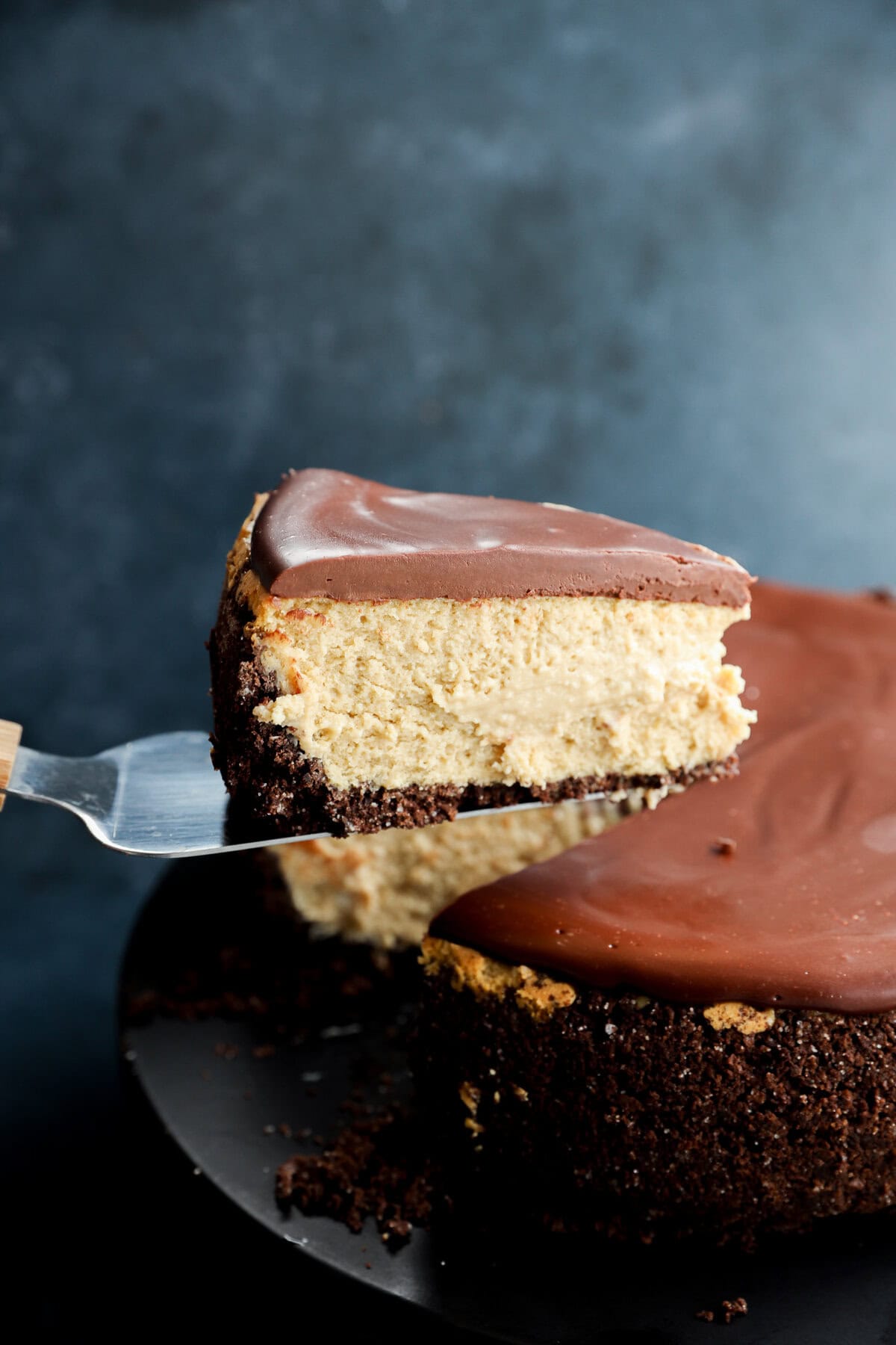 lifting a slice of baileys cheesecake up with a cake slicer