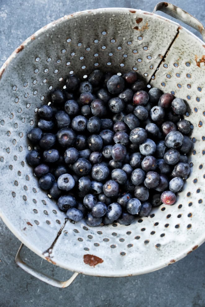 fresh blueberries in a colander wet