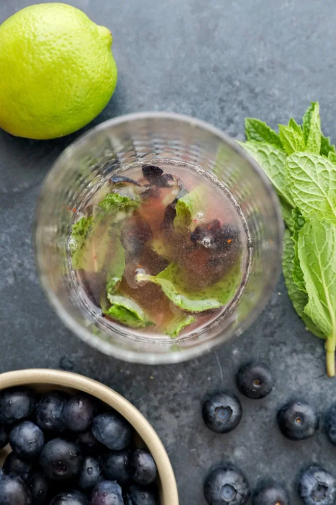 muddled lime juice, sugar, mint leaves, and fresh blueberries