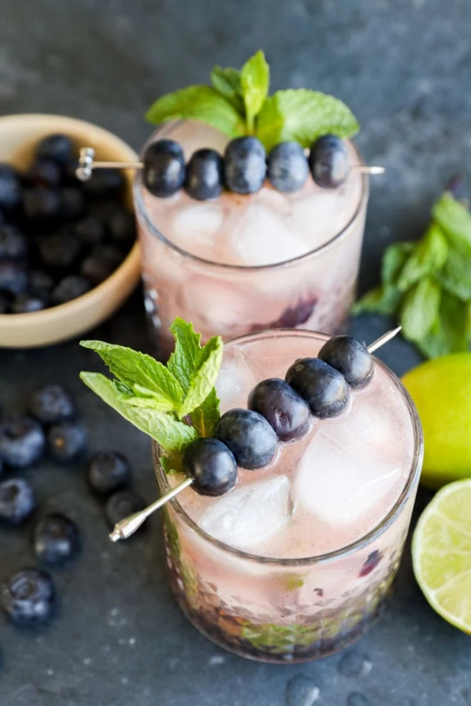 glasses of blueberry mojito with mint and blueberry garnish