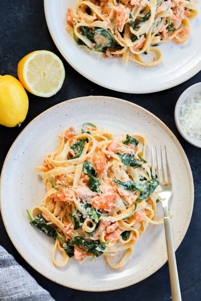 easy weeknight creamy fettuccine recipe on plates with lemons