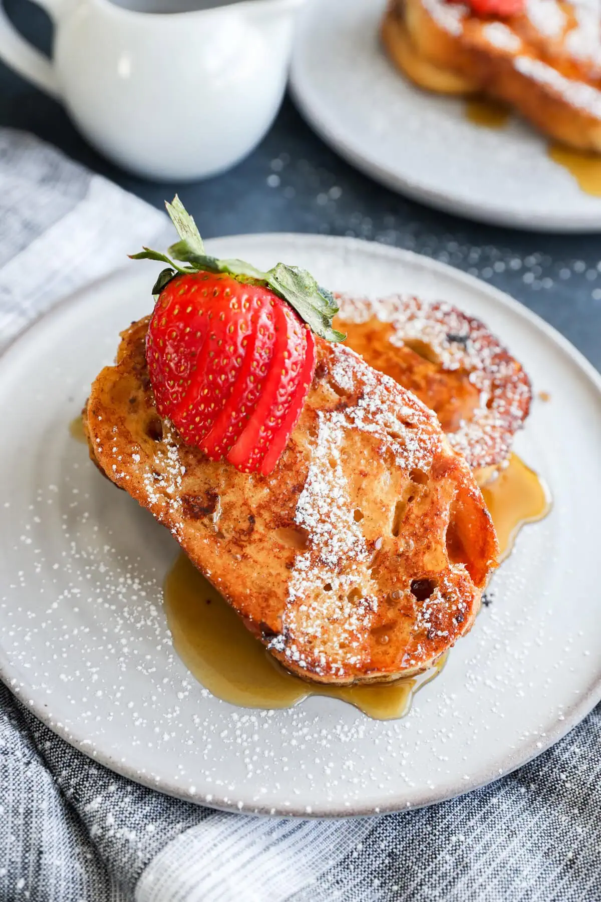 sourdough french toast slices on a plate with fresh fruit